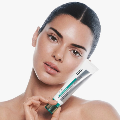 Model holding Anua PDRN Hyaluronic Acid 100 Moisturizing Cream tube near her face