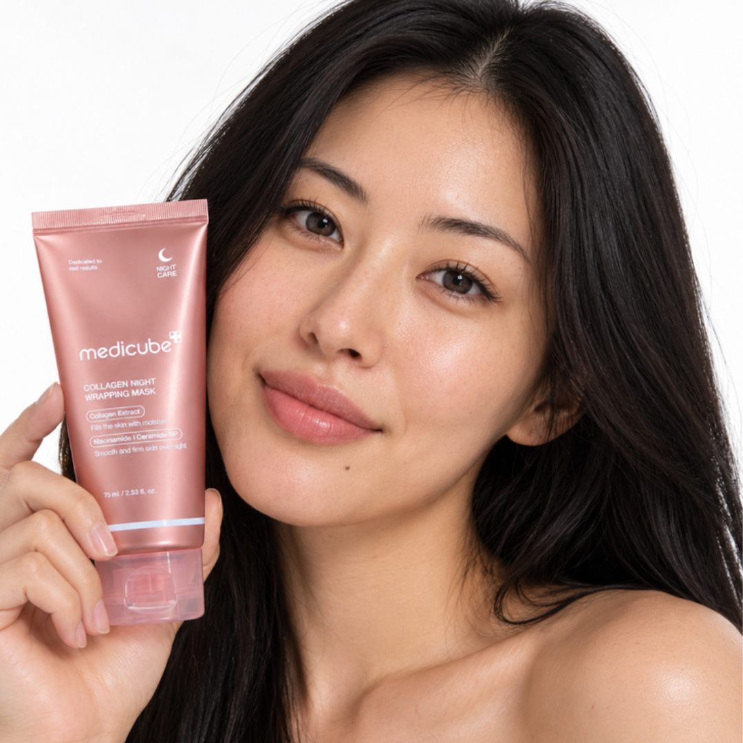 Smiling woman holding Medicube Collagen Night Wrapping Mask next to her face
