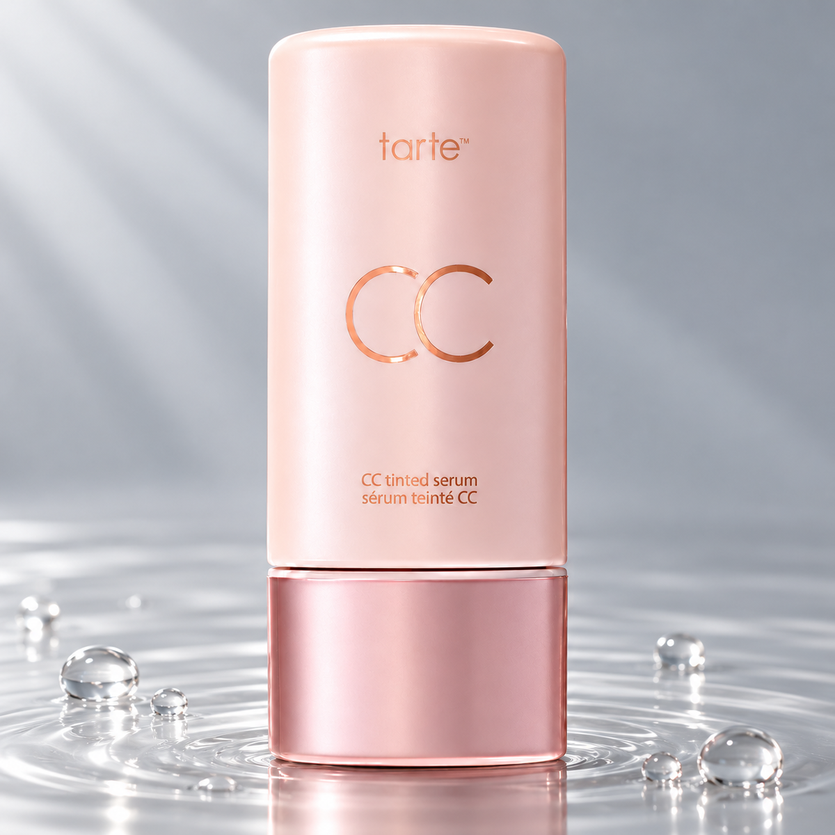 Tarte CC Color-Correcting Tinted Serum bottle standing in clear water on a light grey studio background