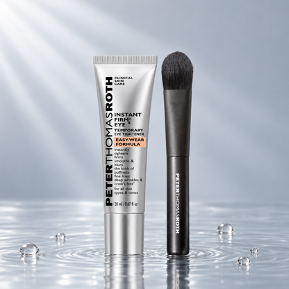 Peter Thomas Roth Instant FIRMx Eye tube and brush standing in clear water on a light grey studio background