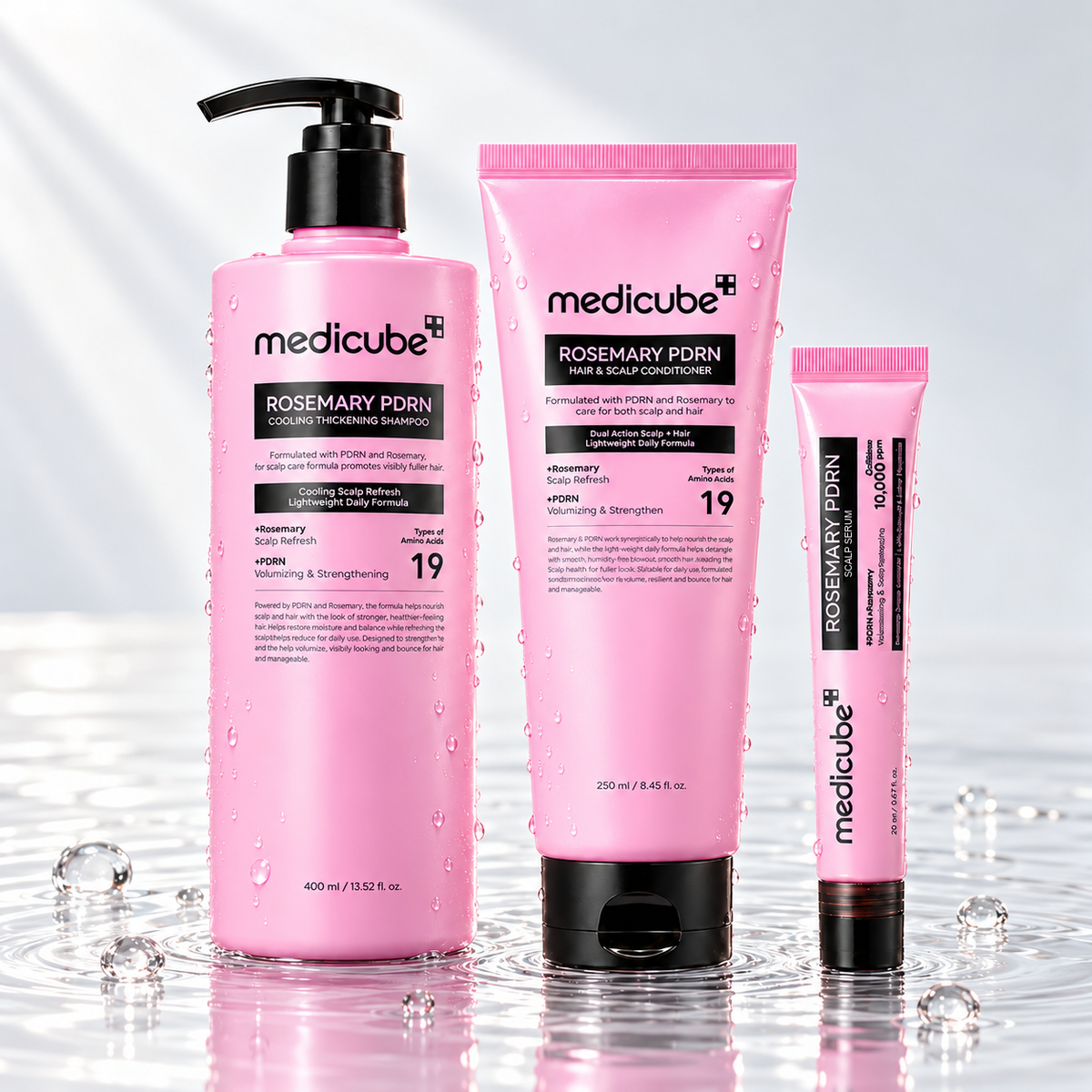 Medicube Rosemary PDRN shampoo, conditioner and hair serum standing in clear water on a light studio background