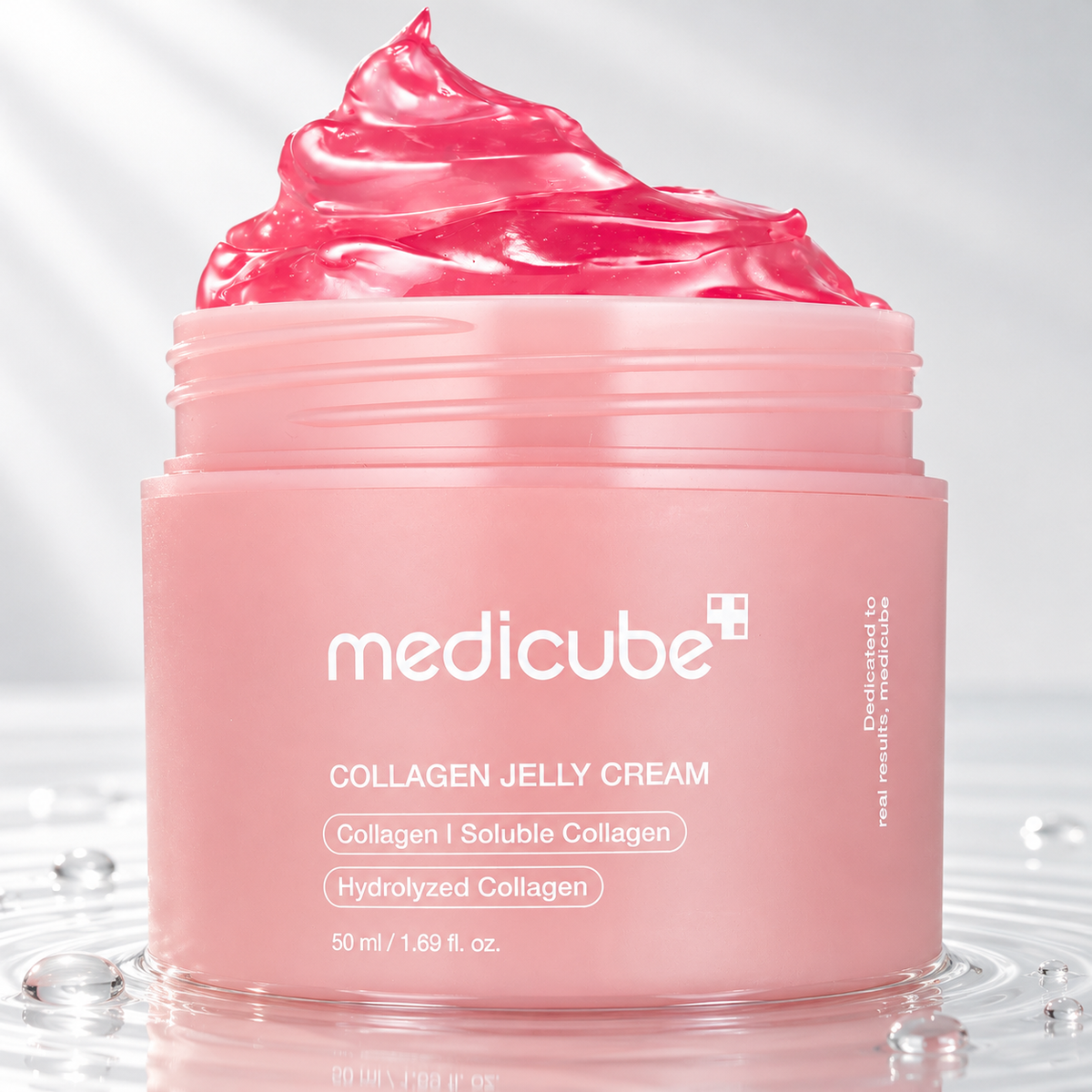 Medicube Collagen Jelly Cream jar with pink jelly standing in clear water on a light studio background