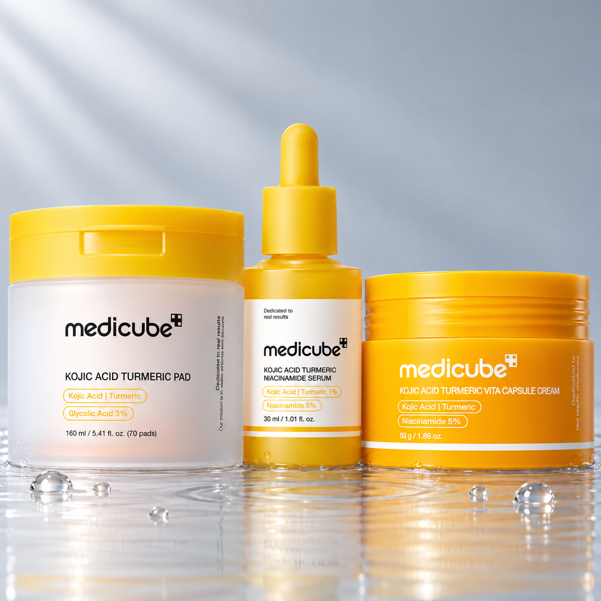 Medicube Kojic Acid Turmeric pad, serum and vita capsule cream standing in clear water