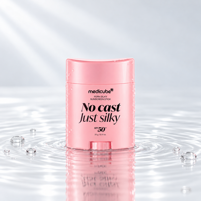Medicube PDRN Silky Sunscreen Stick SPF50+ standing in clear water on a light studio background