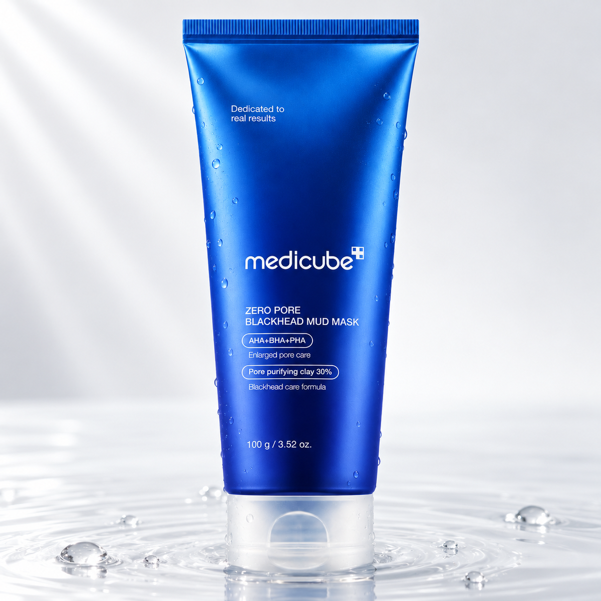 Medicube Zero Pore Blackhead Mud Mask tube standing in clear water on a light studio background